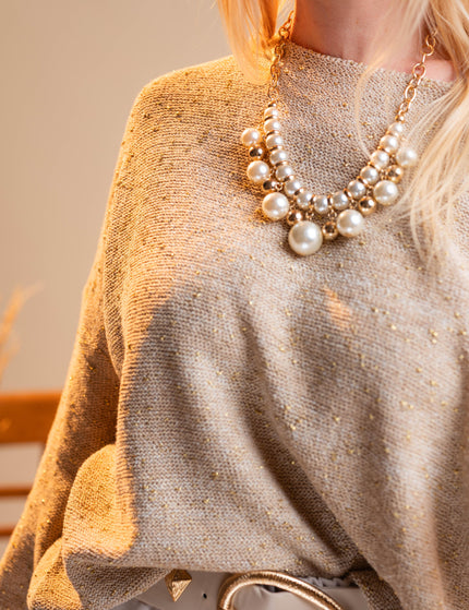 Bež pulover z zlatimi detajli